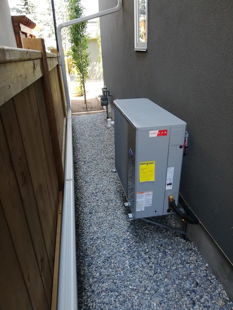Carrier air conditioner installed by Caloris beside a Calgary home