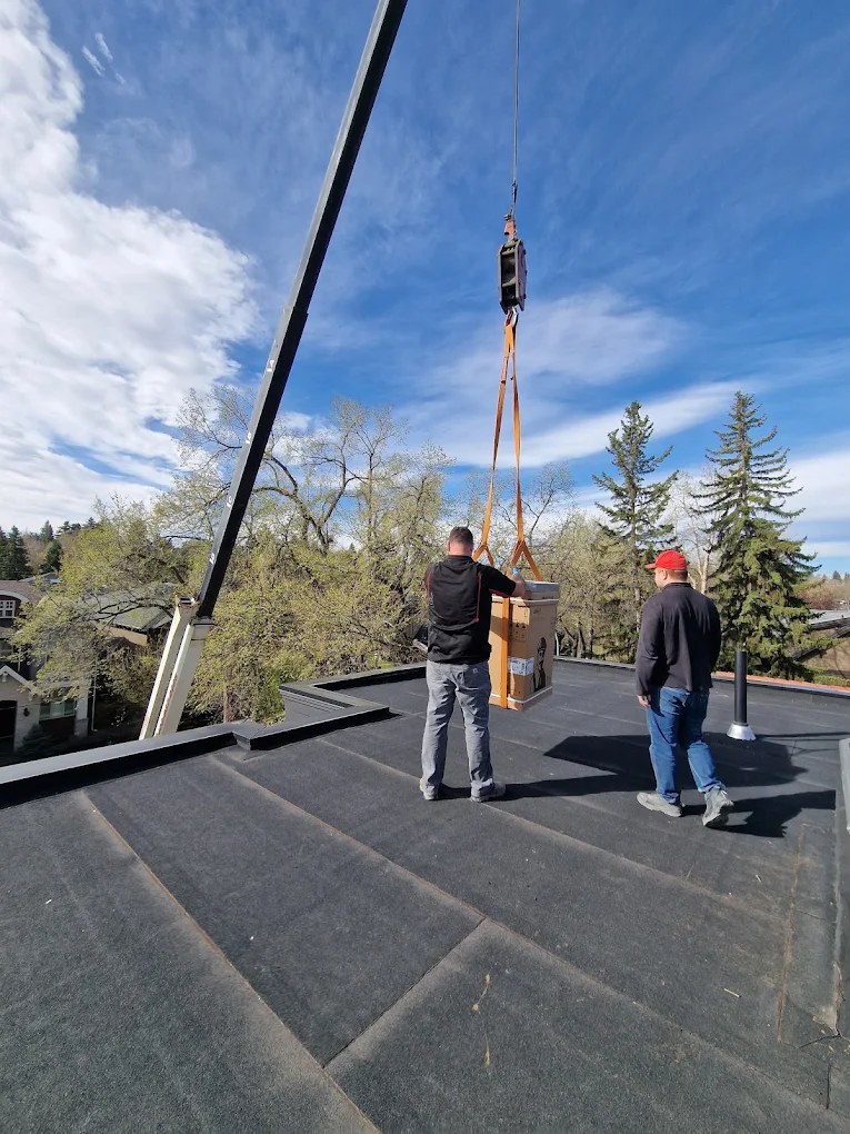 The Caloris crew craning rooftop HVAC equipment into place in Calgary